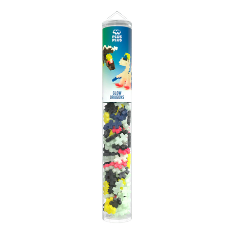 A cylindrical container of Plus-Plus glow-in-the-dark dragon building pieces. The tube is transparent, showcasing multicolored interlocking shapes inside.