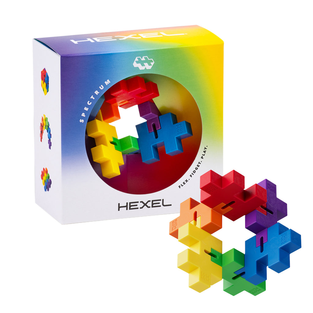 Colorful puzzle toy with interlocking pieces in yellow, red, blue, and more. Packaging says "Hexel Spectrum" with a playful, vibrant design.
