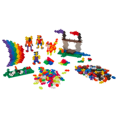 Plus-Plus building toy set with colorful interlocking pieces, a rainbow, figures, and castle on a white background.