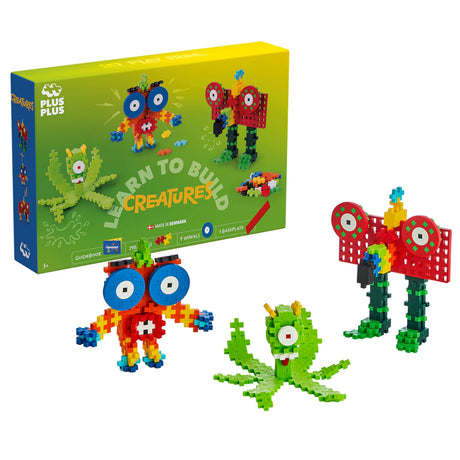 Plus-Plus Learn to Build Creatures set with colorful bricks and three assembled monster figures for creative STEM play.