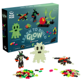 Toy set box with "Learn to Build Glow" kit. Includes 160 bright, glowing pieces forming figures like a ghost and alien, against a white background.