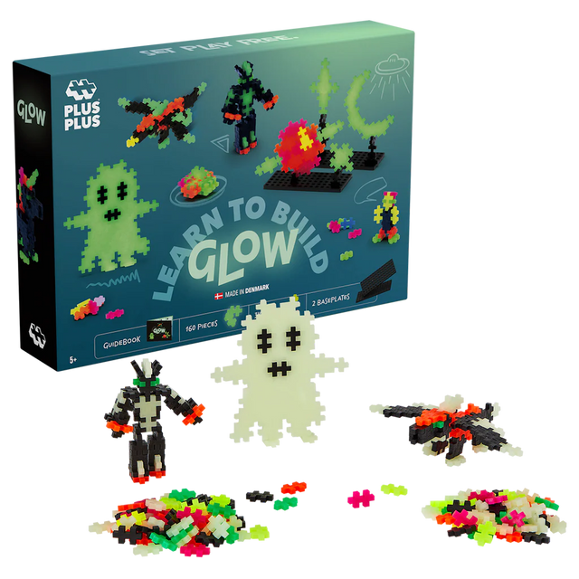 Toy set box with "Learn to Build Glow" kit. Includes 160 bright, glowing pieces forming figures like a ghost and alien, against a white background.