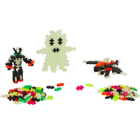 Pixelated ghost, robot, and bat with neon plus-shaped pieces on a white background. Bright colors add a playful, Halloween-themed vibe.