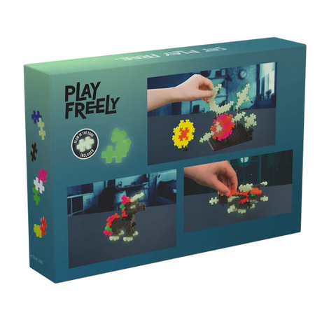 Box of a glow-in-the-dark puzzle toy set labeled "Play Freely." Features colorful interlocking pieces shaped into various structures by hands.