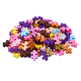 A vibrant pile of colorful, cross-shaped puzzle pieces in pink, yellow, purple, and blue hues, scattered against a white background.
