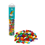 A cylindrical container filled with colorful interlocking puzzle pieces labeled "Rainbow." Pieces are spilled in front, against a white background.