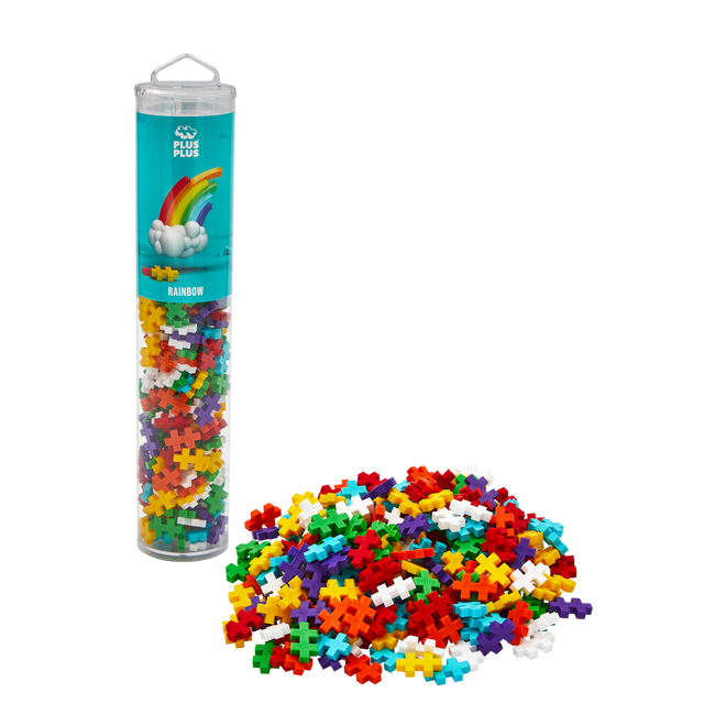 A cylindrical container filled with colorful interlocking puzzle pieces labeled "Rainbow." Pieces are spilled in front, against a white background.