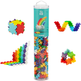A cylindrical container of Plus-Plus Rainbow educational toy pieces on a white background. Surrounding the container are colorful shapes built from the pieces.