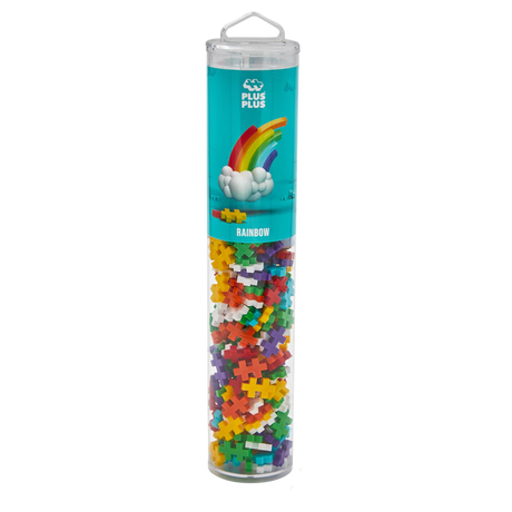Tall, clear tube of colorful interlocking Plus-Plus pieces labeled "Rainbow," featuring a rainbow with clouds on a teal background, set white black.