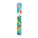 Tall, clear tube filled with colorful building blocks in the shape of plus signs. The label shows a rainbow unicorn model, evoking creativity and fun.