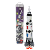 Toy rocket model made from interlocking Plus-Plus pieces in a clear tube with space-themed packaging. The colorful rocket stands upright, exuding creativity.