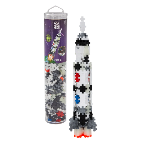 Toy rocket model made from interlocking Plus-Plus pieces in a clear tube with space-themed packaging. The colorful rocket stands upright, exuding creativity.