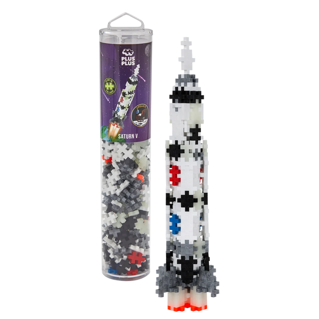 Toy rocket model made from interlocking Plus-Plus pieces in a clear tube with space-themed packaging. The colorful rocket stands upright, exuding creativity.