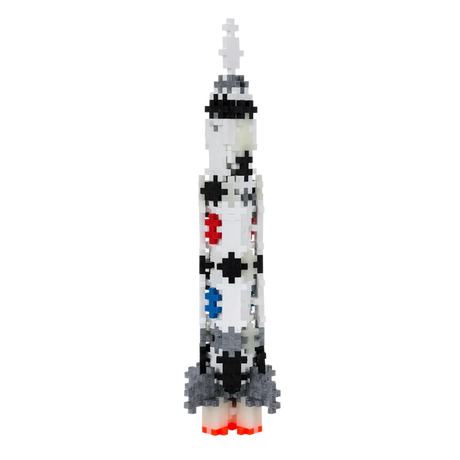 A pixelated rocket made of interlocking blocks features black dots and colorful patterns of red, blue, and gray, against a solid white background.