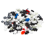 A pile of interlocking puzzle pieces in various colors like white, black, blue, red, and gray stands out against a white background, conveying a playful and creative tone.