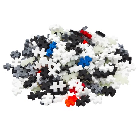 A pile of interlocking puzzle pieces in various colors like white, black, blue, red, and gray stands out against a white background, conveying a playful and creative tone.