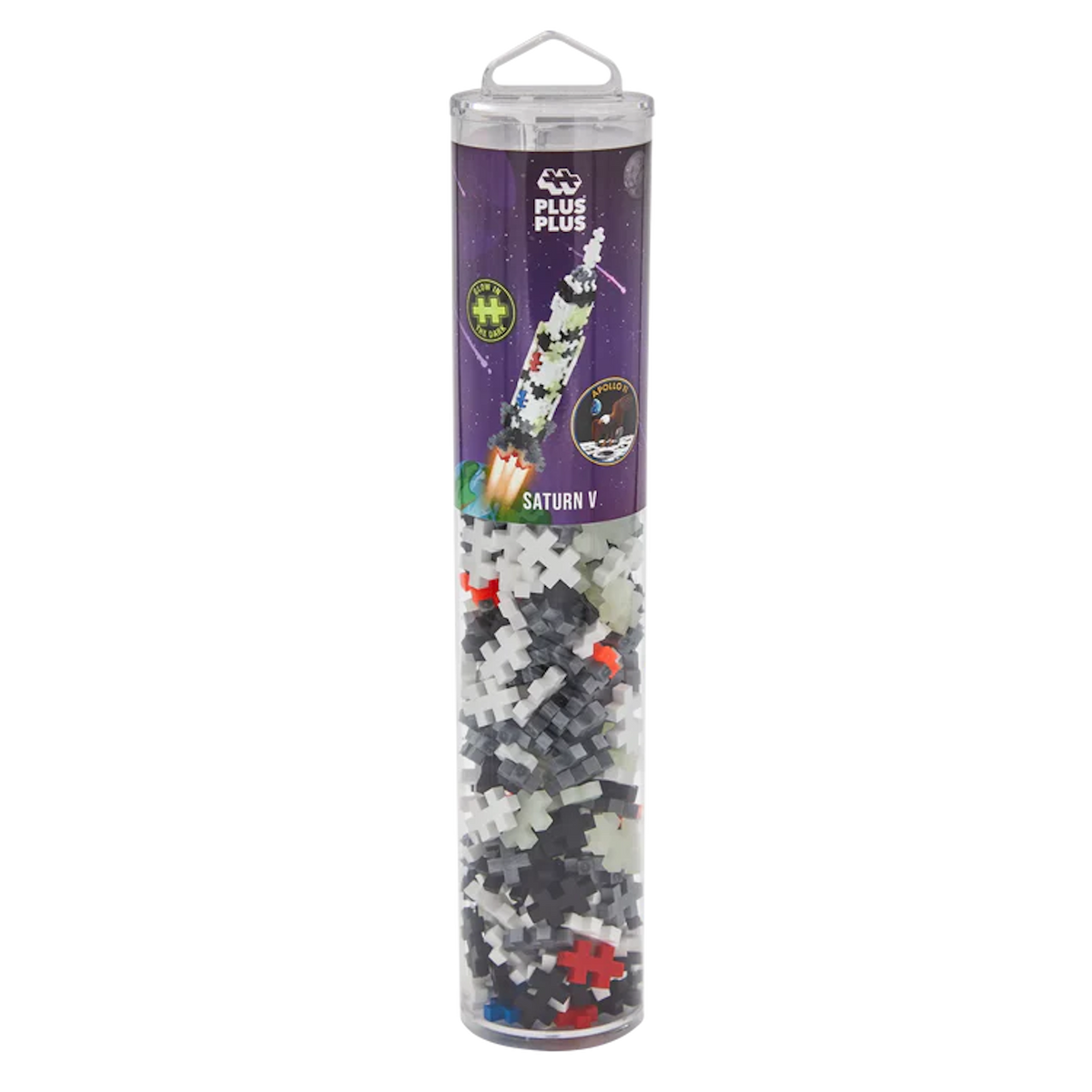 A clear cylindrical container holds Plus-Plus building pieces. The label depicts a rocket titled "Saturn V" against a starry background, suggesting space-themed play.