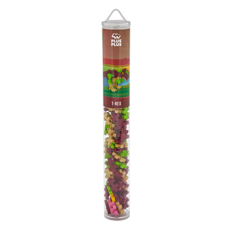 A tall, transparent tube labeled "Plus Plus T-Rex" contains colorful interlocking building blocks in shades of red, green, and beige, set against a white background.