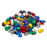 A pile of colorful Plus-Plus interlocking building blocks in various shades like blue, green, yellow, red, and white.