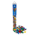Plus-Plus Basic building blocks in a clear travel tube with a pile of colorful cross-shaped pieces on a white background.
