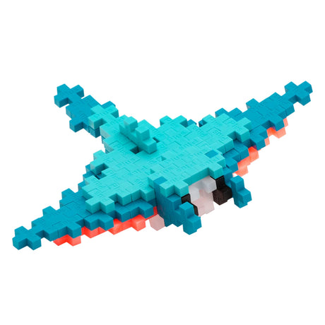 Blue and teal Plus-Plus blocks assembled into a manta ray shape with an orange underside on a white background.