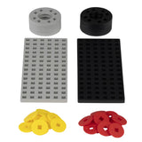 Plus-Plus accessory pack with grey and black baseplates, wheels, and yellow and red hubcaps for building toy sets.