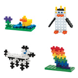 Four Plus-Plus block creations: a duck on a pond, a penguin, a spotted dog, and a rainbow stack on green baseplates.