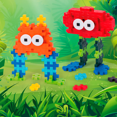 Two colorful Plus-Plus toy creatures, one red and one orange, standing in a vibrant green jungle setting.