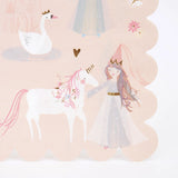 A pink scalloped napkin featuring a fairytale illustration of a princess petting a white unicorn.