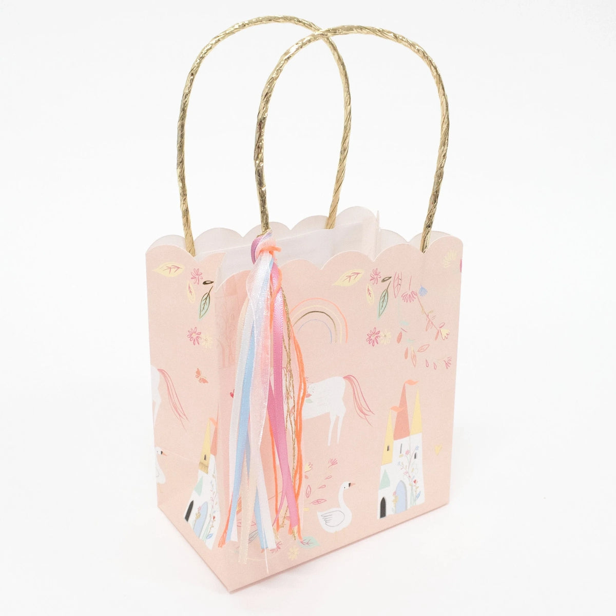 Pink unicorn-themed gift bag with gold handles and colorful ribbons.
