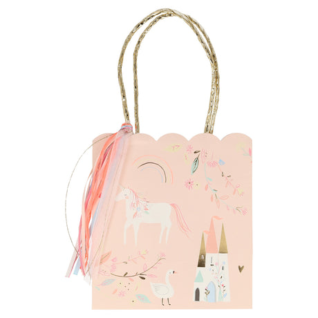 Pink gift bag with gold handles, a colorful tassel, and an illustration of a unicorn and a castle.
