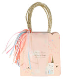 A pack of Meri Meri pink party bags with gold handles, tassels, and a castle illustration.