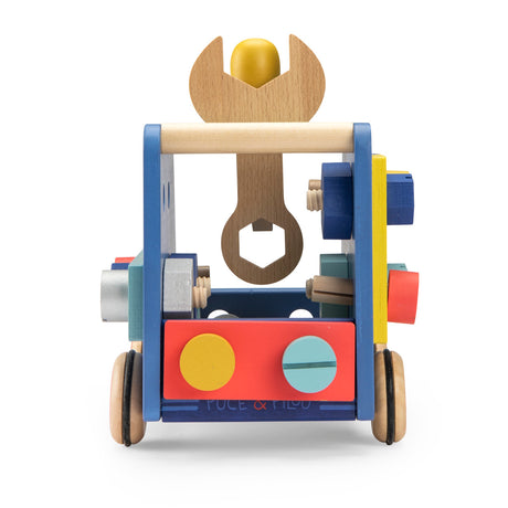 Rear view of a blue wooden toy truck featuring a large wrench handle, colorful screws, and "Puce & Pilou" text.