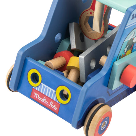 A blue wooden Moulin Roty toy handyman truck filled with wooden tools, nuts, and bolts on a white background.