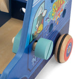Close-up of a blue wooden toy truck with a teal screw, wooden nut, and wheels featuring a red and blue design.