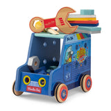 Blue wooden Moulin Roty toy handyman truck with a wooden wrench, colorful planks, and bolts on a white background.