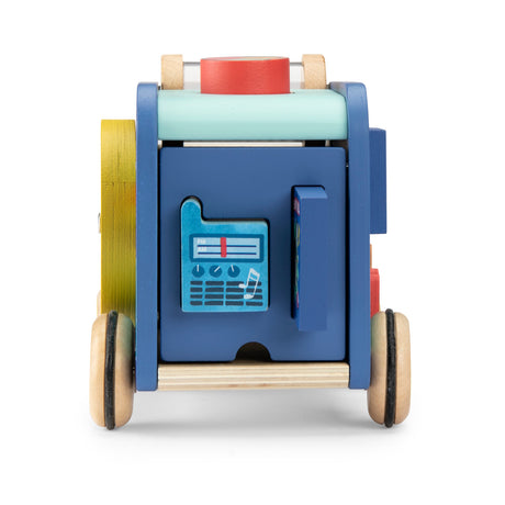 Rear view of a blue wooden toy van featuring a radio illustration and wheels with black rubber grips.