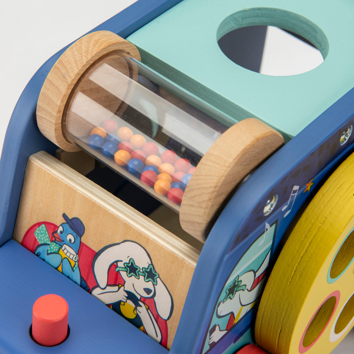 Close-up of a blue wooden toy car featuring a clear rattle cylinder with colorful beads and cartoon animal illustrations.