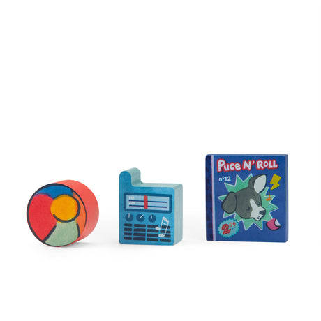 Three colorful wooden toy blocks: a red cylinder, a blue radio-shaped piece, and a blue square with a dog illustration.
