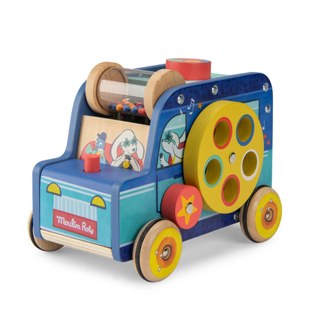 A colorful wooden Moulin Roty multi-activity toy car with gears, a bead shaker, and illustrations of animals driving.