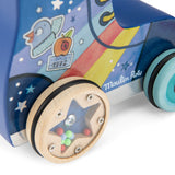 Wooden pull-along roller skate toy with a rainbow design, star-shaped rattle wheels, and "Moulin Roty" branding.