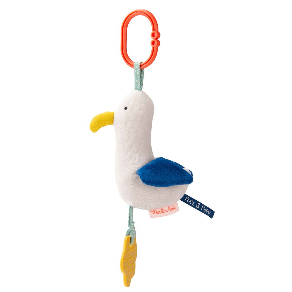 Plush seagull toy with a yellow beak, blue wings, and textured yellow feet. It hangs from a red clip, conveying a playful and cheerful tone.