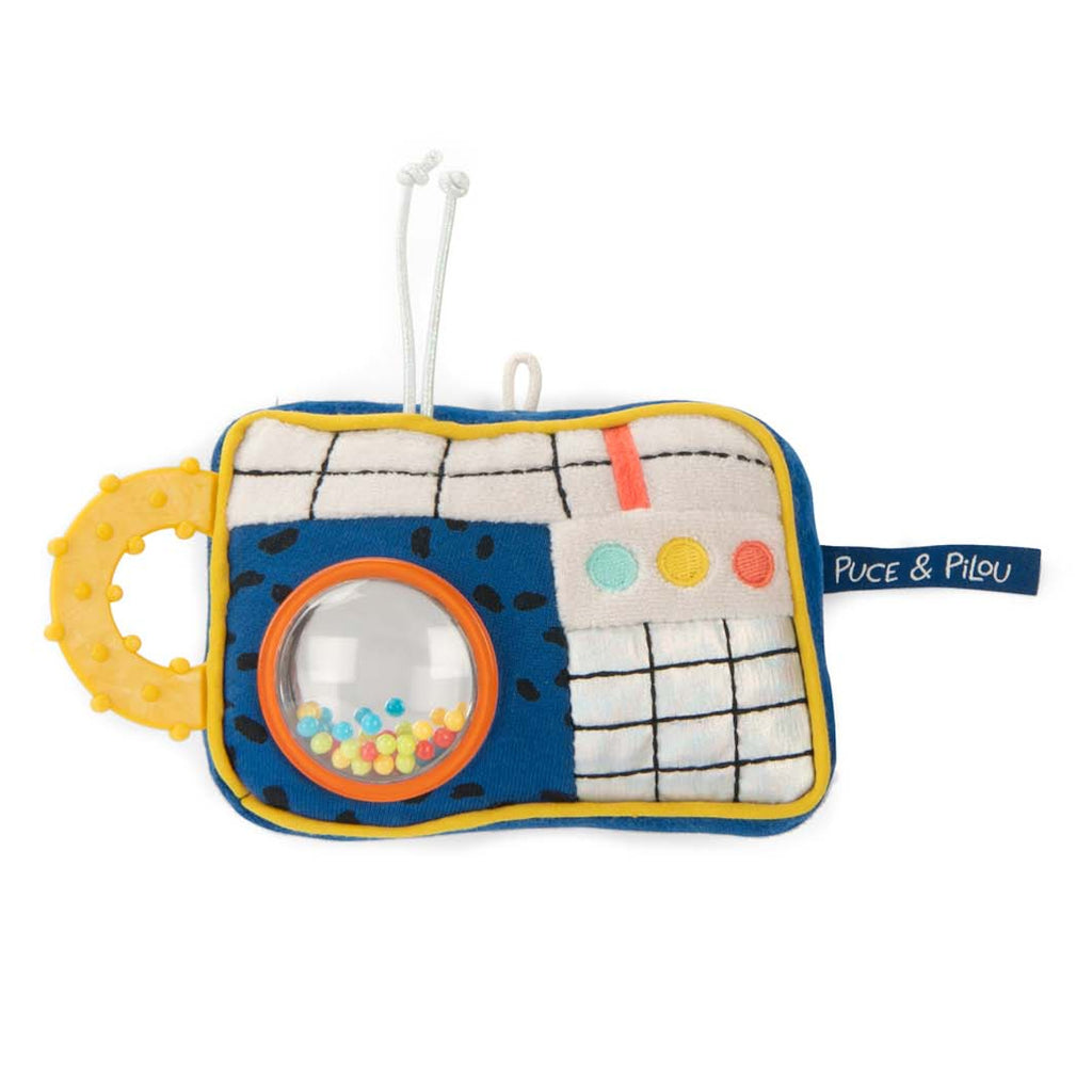 Soft, colorful fabric toy resembling a radio with a yellow teething handle, grid pattern, buttons, and a clear window with small, colorful beads.