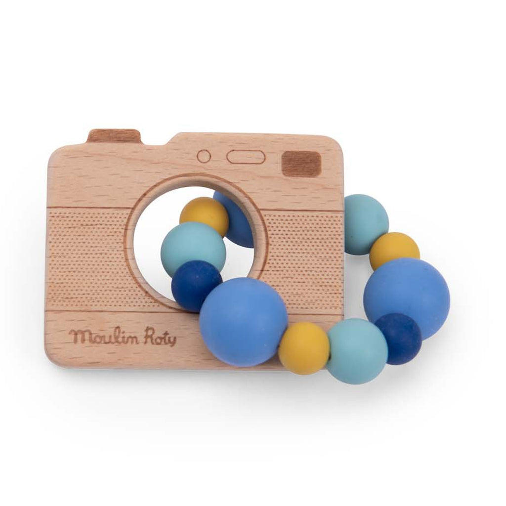 Wooden toy camera with a ring of colorful beads in blue, yellow, and teal. The camera has engraved details, creating a playful and cheerful tone.