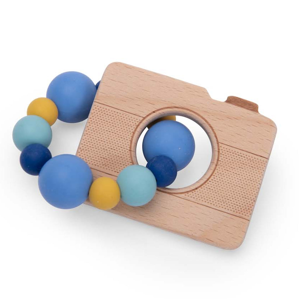 Wooden toy camera with a ring of colorful beads in blue, yellow, and teal. The camera has engraved details, creating a playful and cheerful tone.