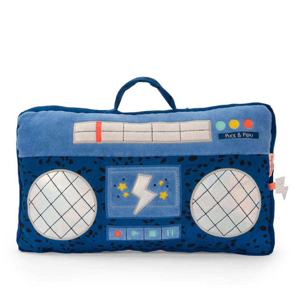 Plush rectangular cushion shaped like a blue boombox, with circular speakers, colorful buttons, and a handle. It has playful, retro design elements.