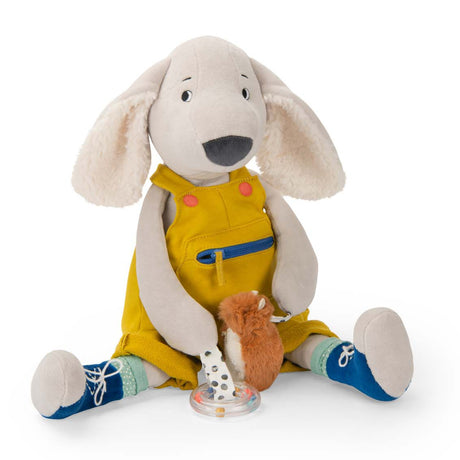Plush activity dog toy wearing yellow overalls and blue shoes sitting with small attached sensory toys.