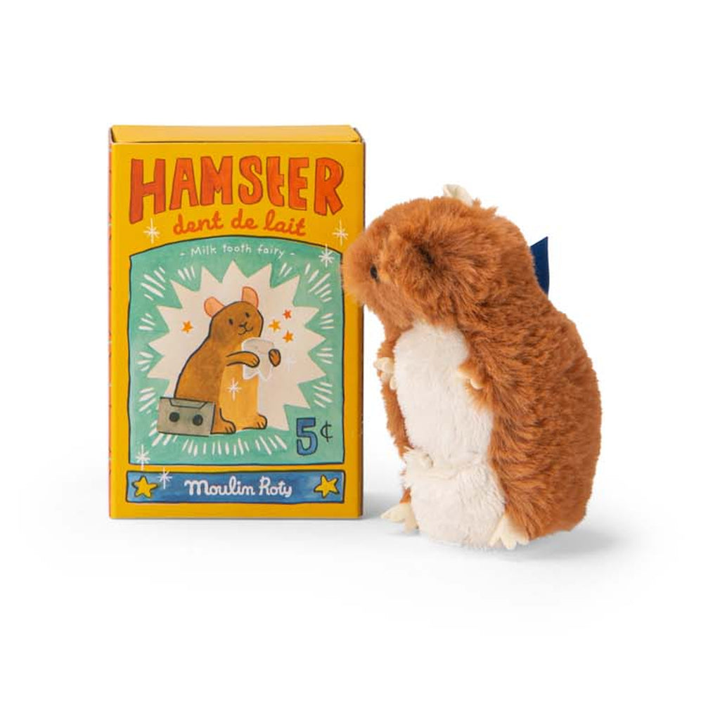 A plush hamster toy sits beside a colorful box labeled "Hamster dent de lait." The box features an illustrated hamster and bright, playful graphics.