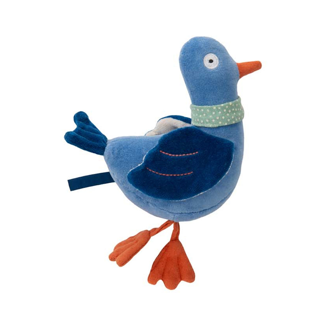 Plush toy blue bird with an orange beak and feet. The scene conveys a playful and whimsical tone.
