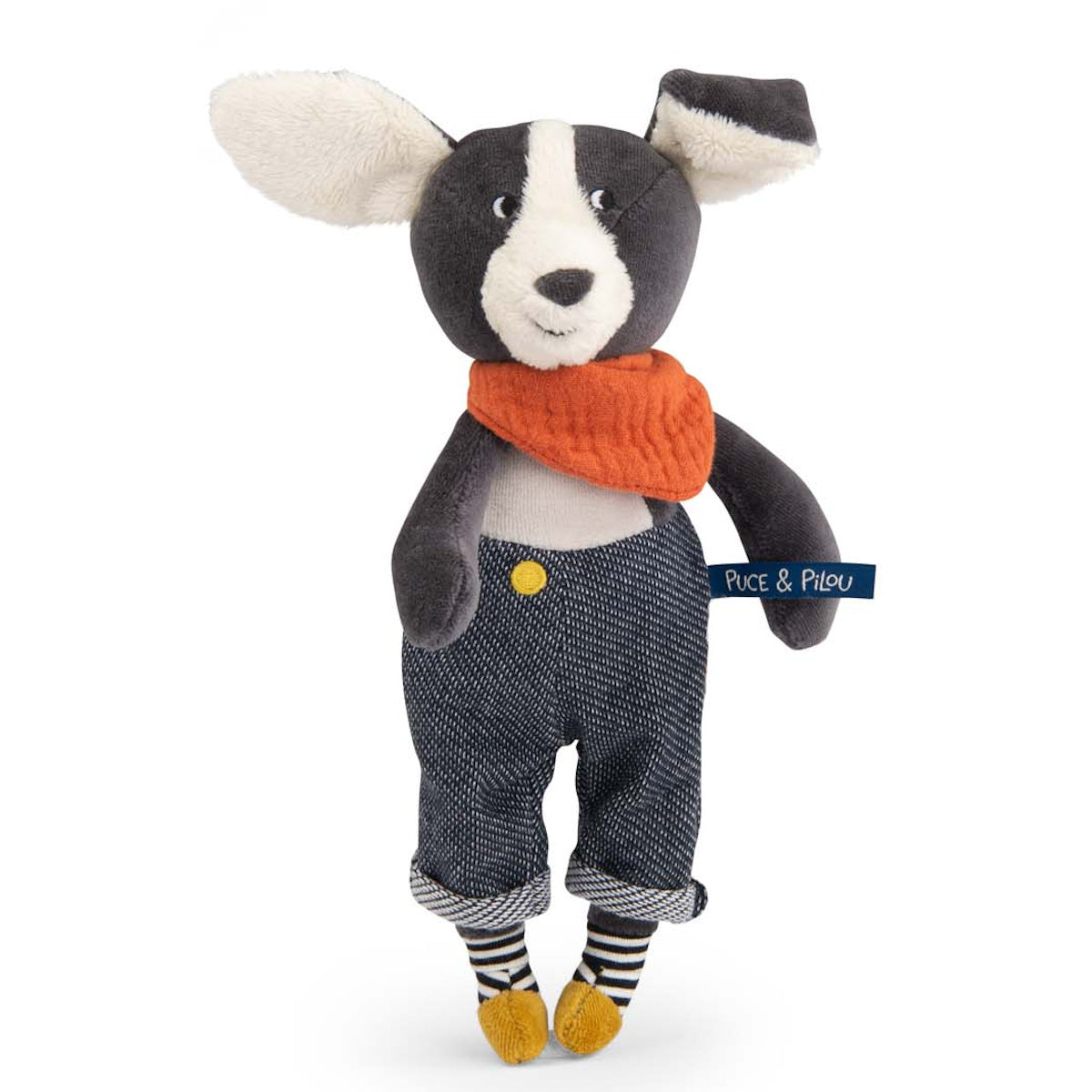 Plush black and white dog toy wearing an orange scarf, denim trousers, and striped socks.